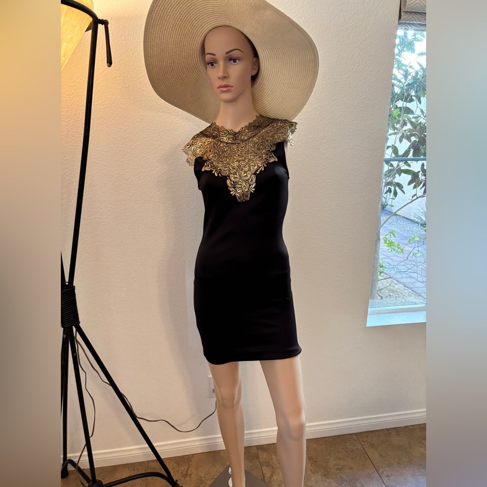 Elegant Black and Gold Dress with sheer back. Gently used!Gorgeous evening dress